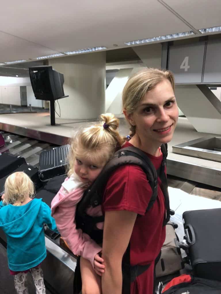 When you're traveling with kids on your own, consider babywearing: You'll have more hands to handle the luggage, tickets + everything else! To & Fro Fam