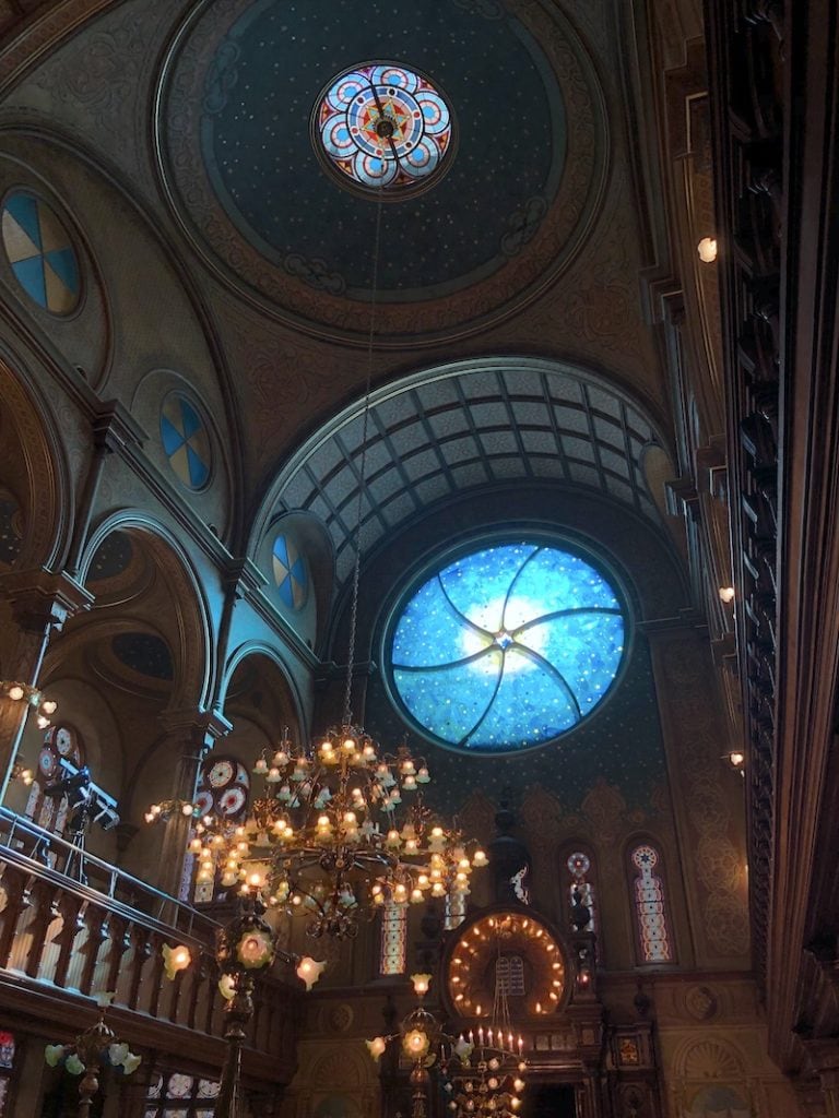 One of the best hidden gems in NYC: The Eldridge Street Museum in the Lower East Side. Gorgeous stained glass in the synagogue's sanctuary is breathtaking. Explore this LES museum in New York to stray off the beaten path and learn about the city's history. Don't miss this! To & Fro Fam